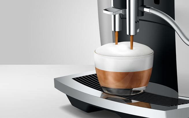 La cafetera E6 Platino de Jura extrayendo un café Capuccino